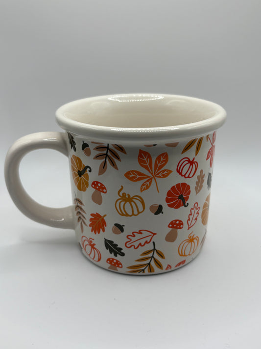 White autumn leaves and pumpkin mug